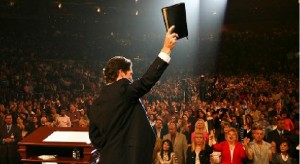 joel-osteen-holding-up-bible